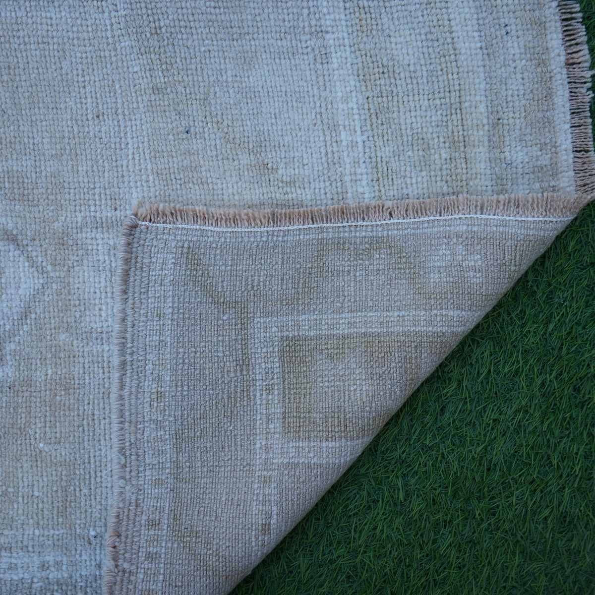 1970s beige Turkish authentic vintage rug with neutral design, hand-knotted weave and low pile.