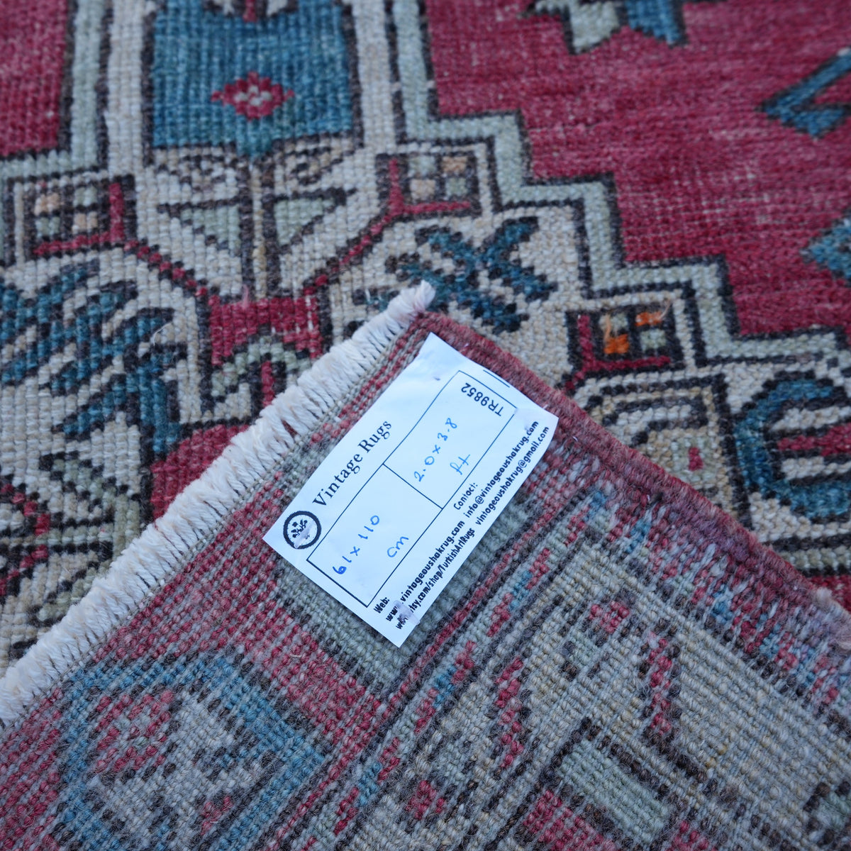 Red 2' x 4' Turkish authentic vintage rug from the 1970s with traditional design.
