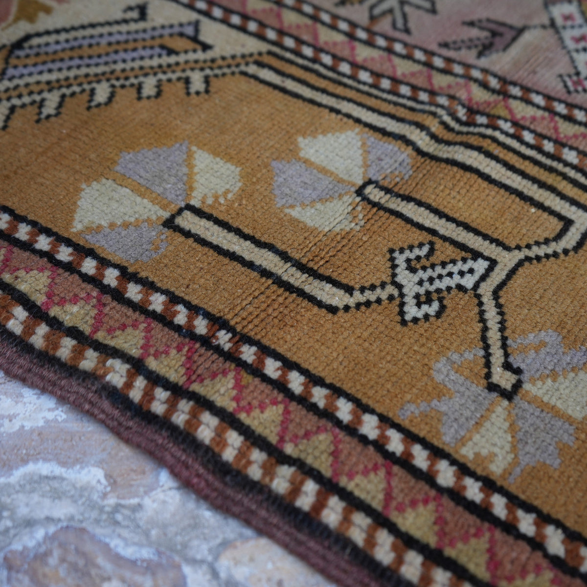 Orange 3' x 4' Turkish authentic vintage rug in wool, shown on the floor.