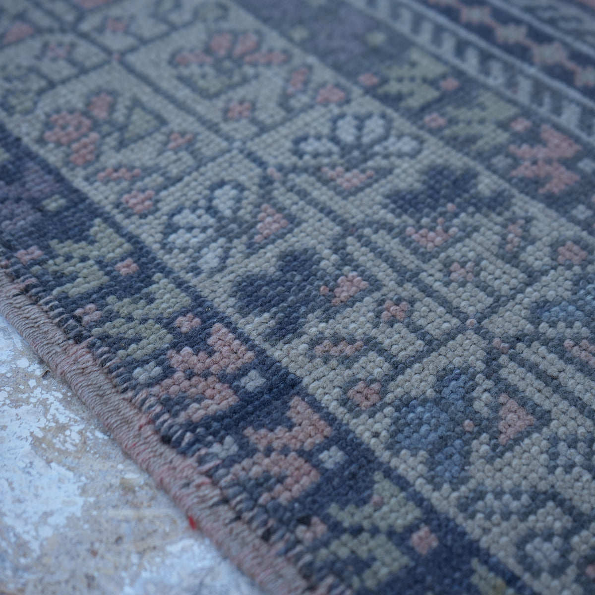 Pink 4' x 7' Turkish authentic vintage rug in wool, shown on the floor.