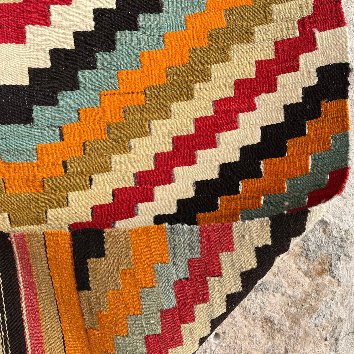 Orange 2' x 4' Turkish flatwoven rugs in wool and cotton, shown on the floor.