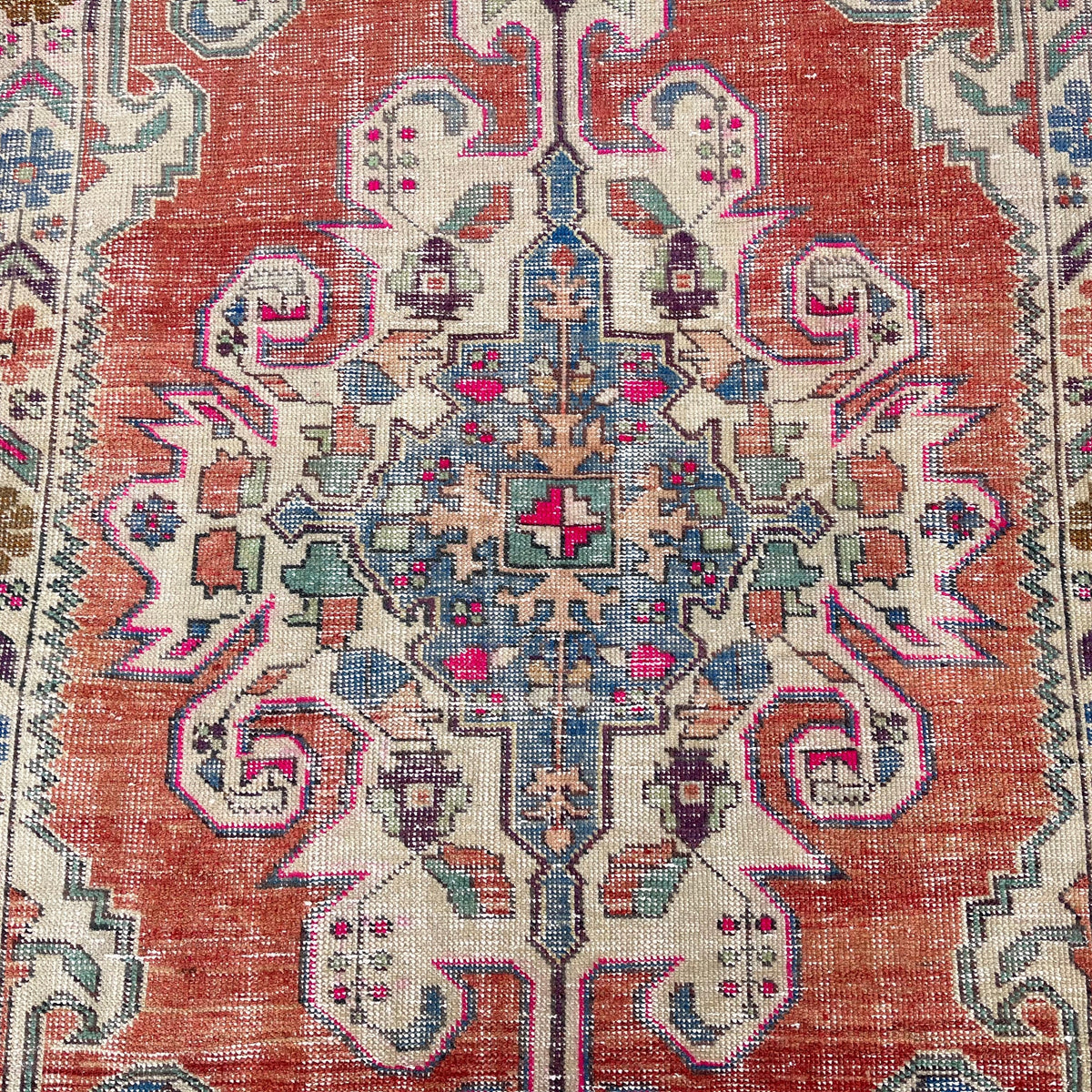 1970s red Turkish handknoted rug with traditional design, hand-knotted weave and low pile.
