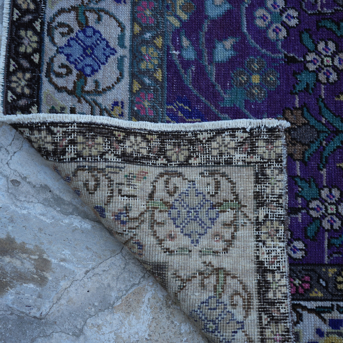 1970s purple Turkish handknotted floral rug with floral design, hand-knotted weave and low pile.