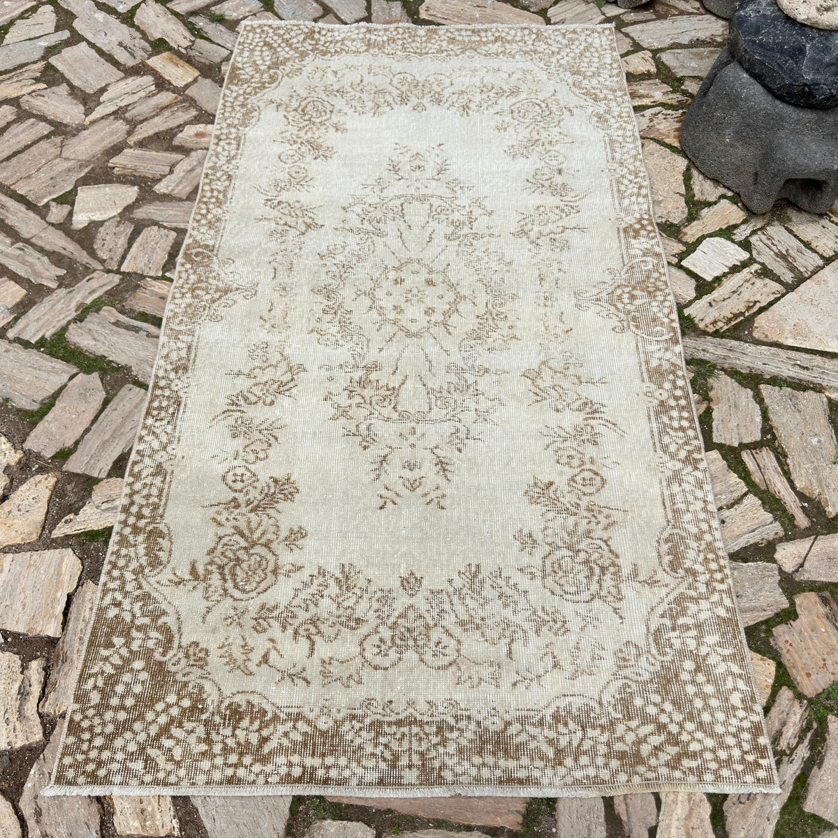 Beige 4' x 7' Turkish handknotted rug in wool and cotton, shown on the floor.