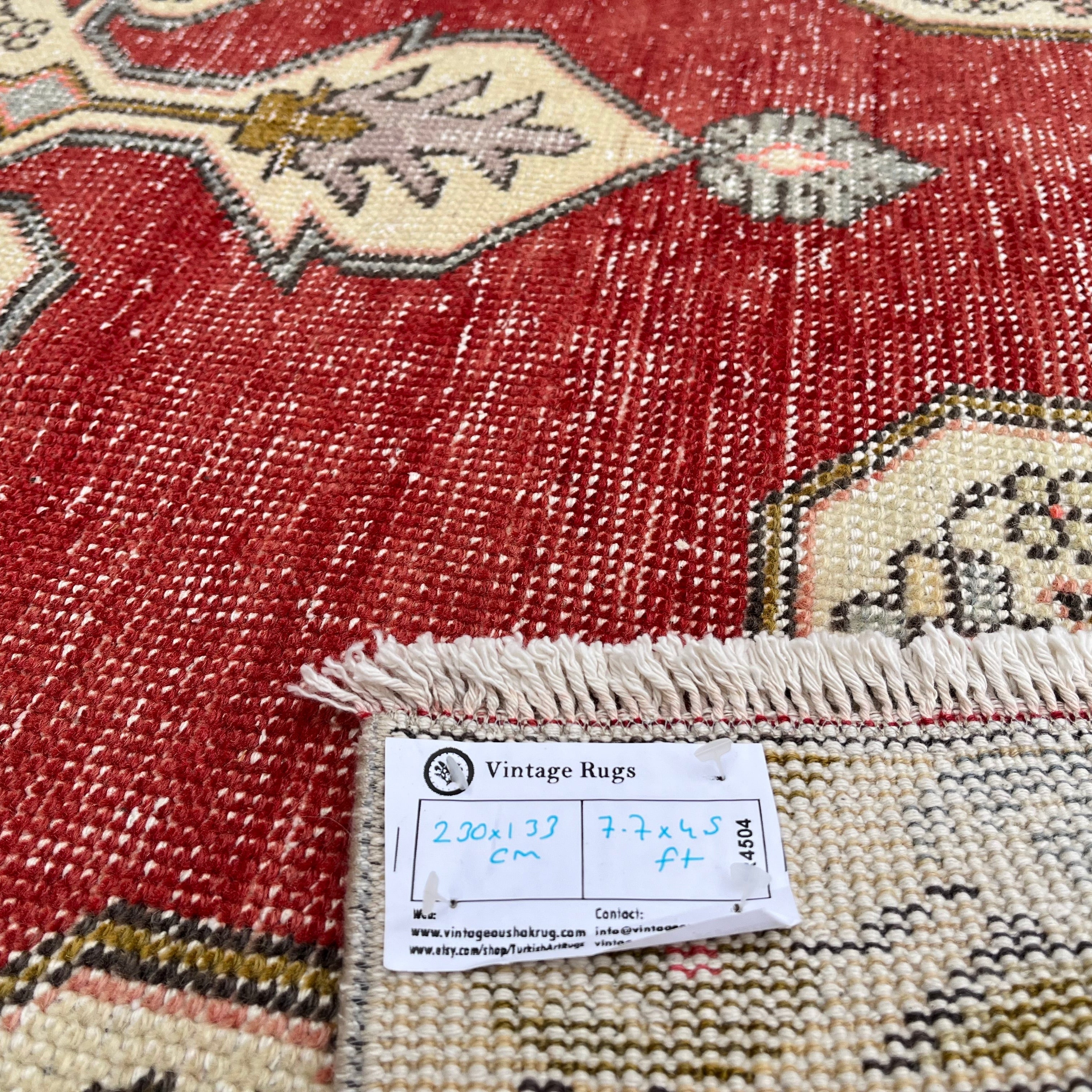 Close-up of the red Turkish handknotted rug showing traditional details, hand-knotted weave, wool and cotton and low pile.
