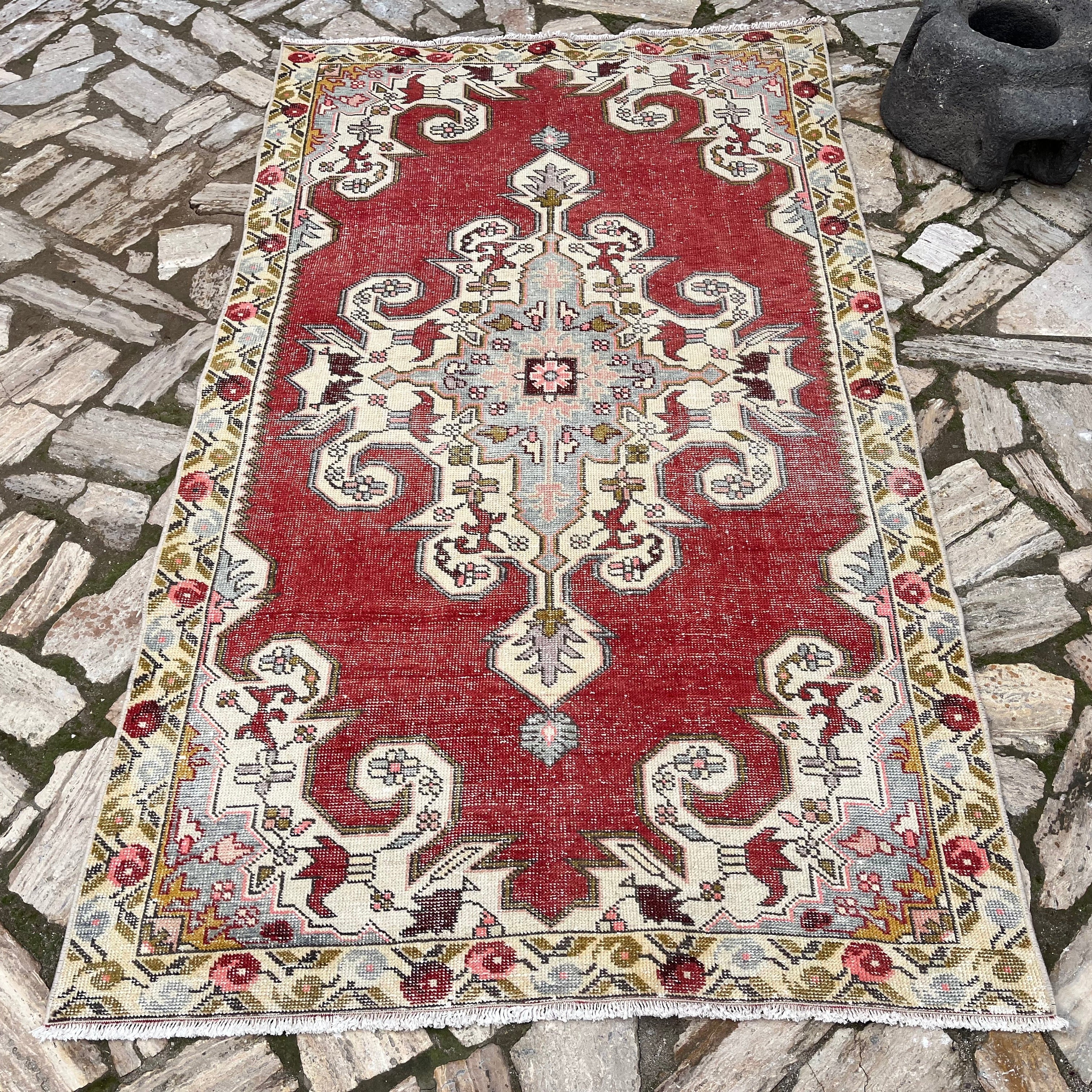 Red 4' x 7' Turkish handknotted rug in wool and cotton, shown on the floor.