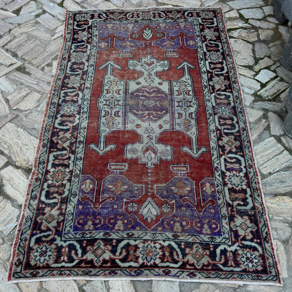Purple 5' x 8' Turkish handknotted rug in wool and cotton, shown on the floor.