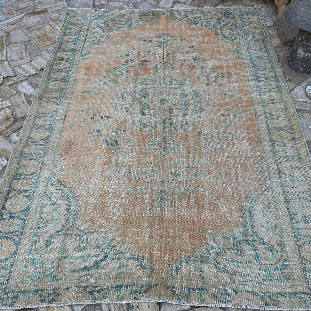 Orange 6' x 9' Turkish handknotted rug in wool and cotton, shown on the floor.