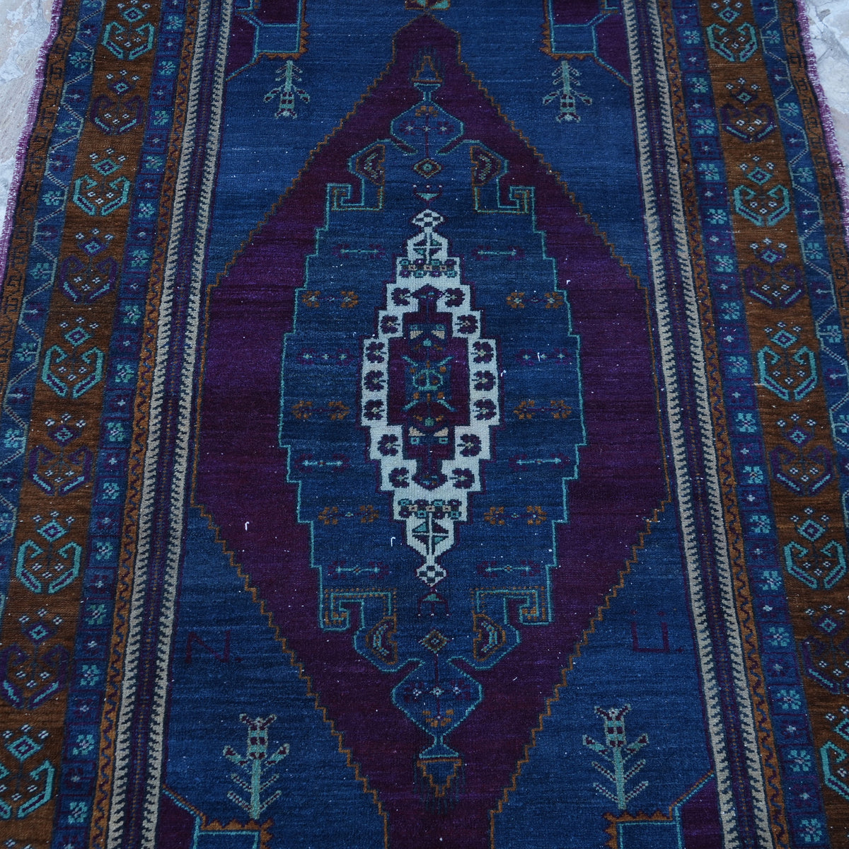 Close-up of the blue Turkish handknotted wool rug showing traditional details, hand-knotted weave, wool and low pile.