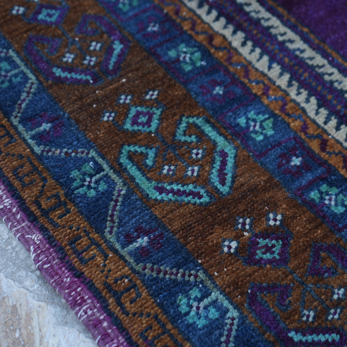 Blue 5' x 8' Turkish handknotted wool rug in wool, shown on the floor.