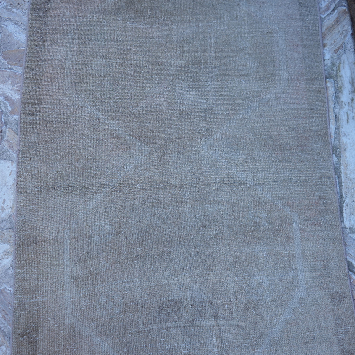 Close-up of the beige Turkish handmade neutral rug showing neutral details, hand-knotted weave, wool and cotton and low pile.