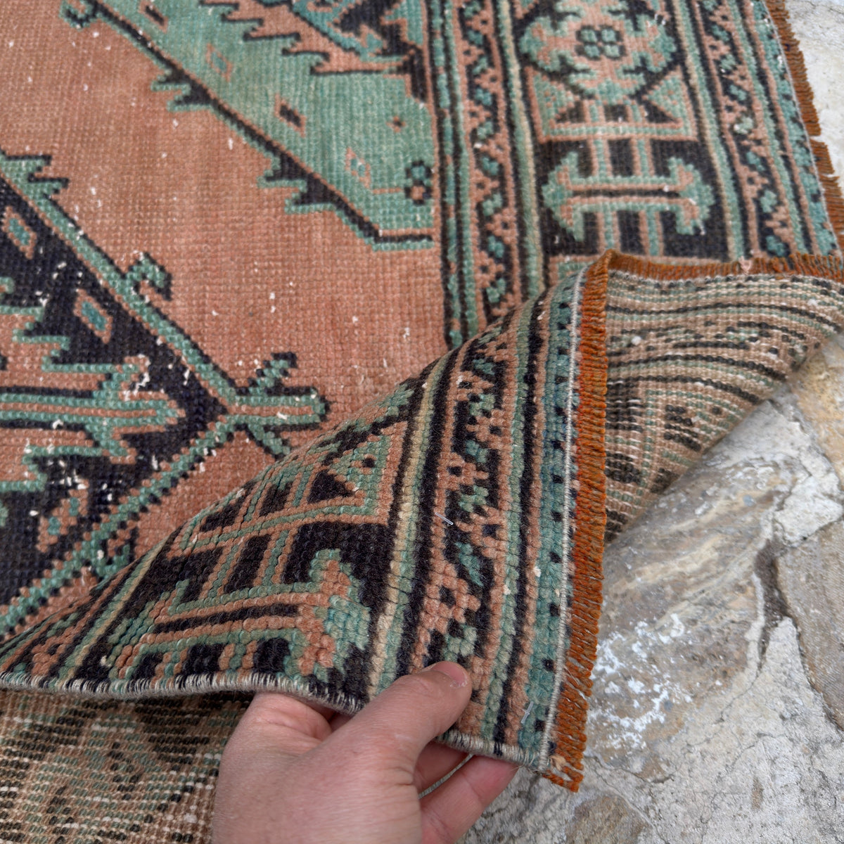 Close-up of the orange Turkish handmade oushak runner rug showing oushak details, hand-knotted weave, wool and low pile.