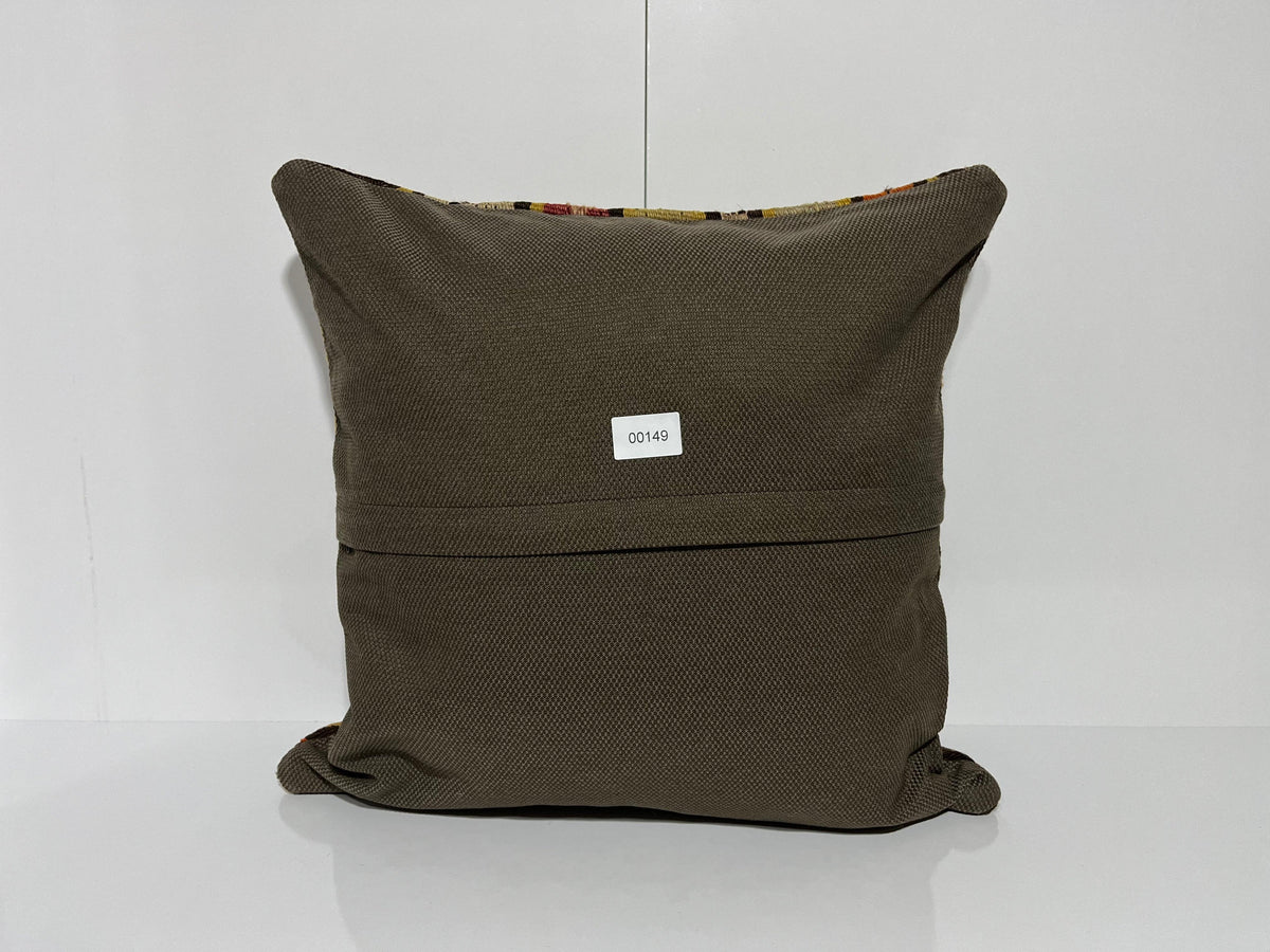 Close-up of the beige Turkish kilim pillow showing traditional details.