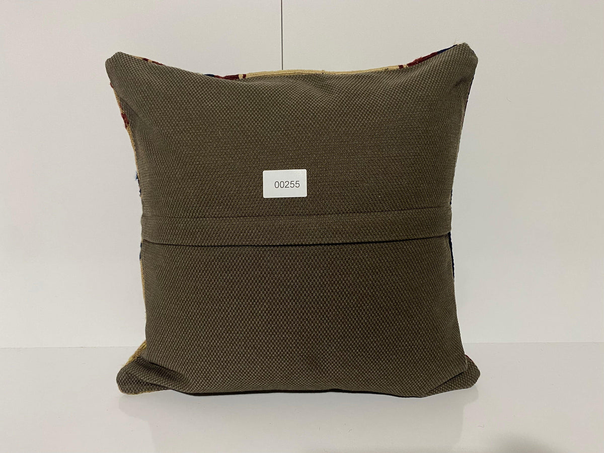 Close-up of the beige Turkish kilim pillow showing geometric details.