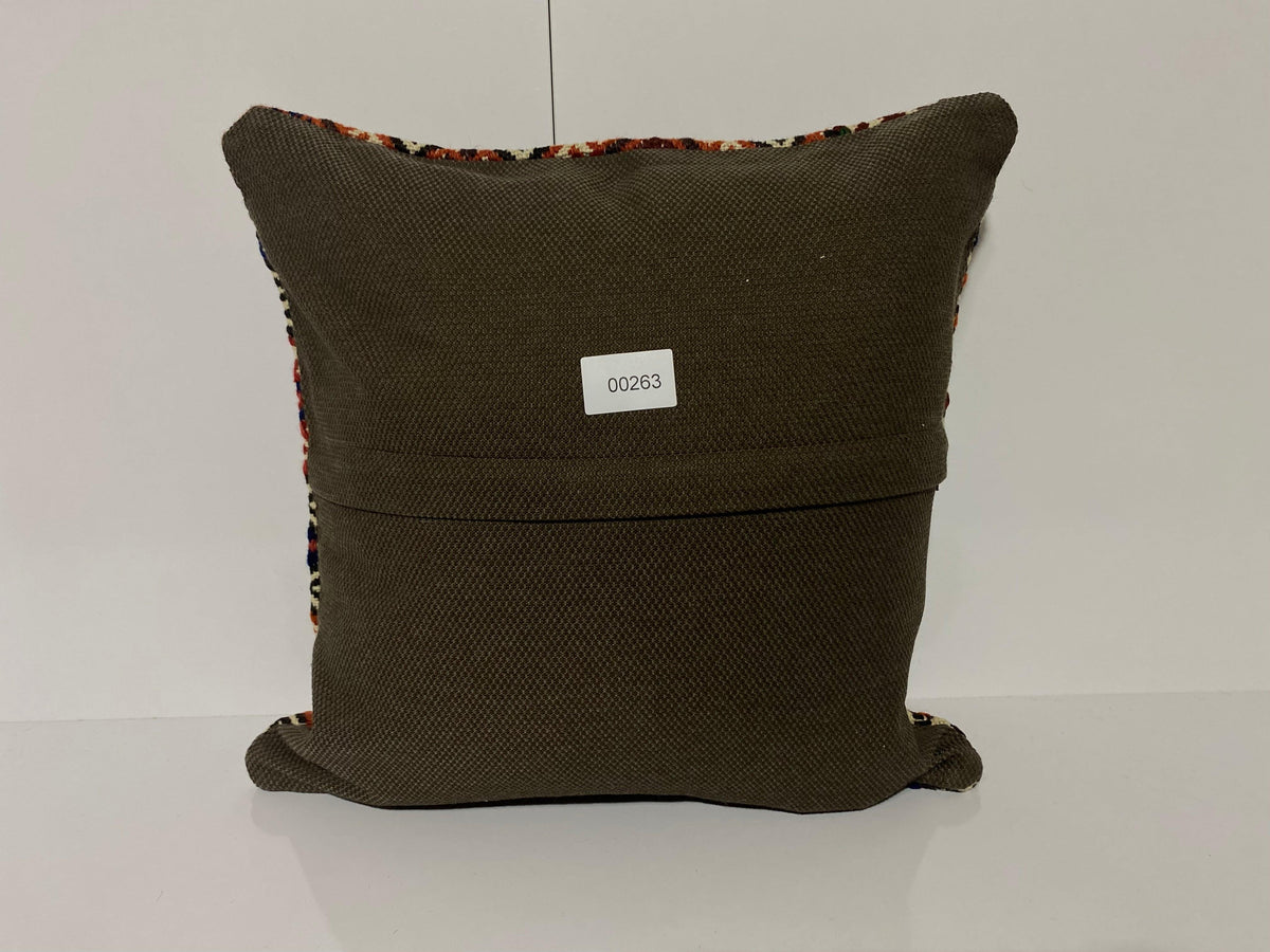 Close-up of the blue Turkish kilim pillow showing geometric details.