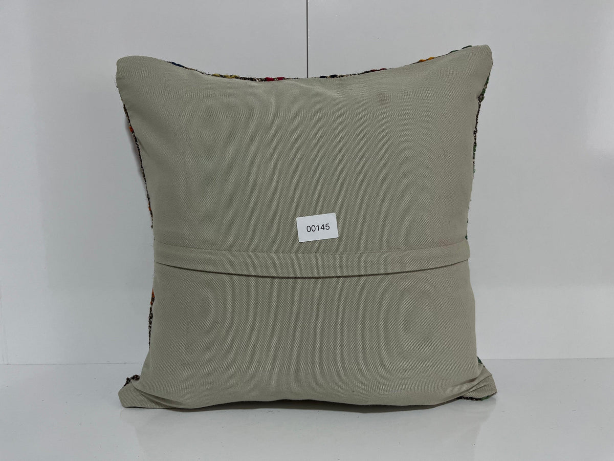 Close-up of the gray Turkish kilim pillow showing traditional details.