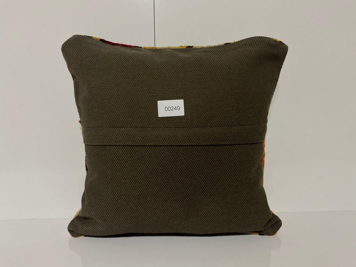 Close-up of the green Turkish kilim pillow showing traditional details.