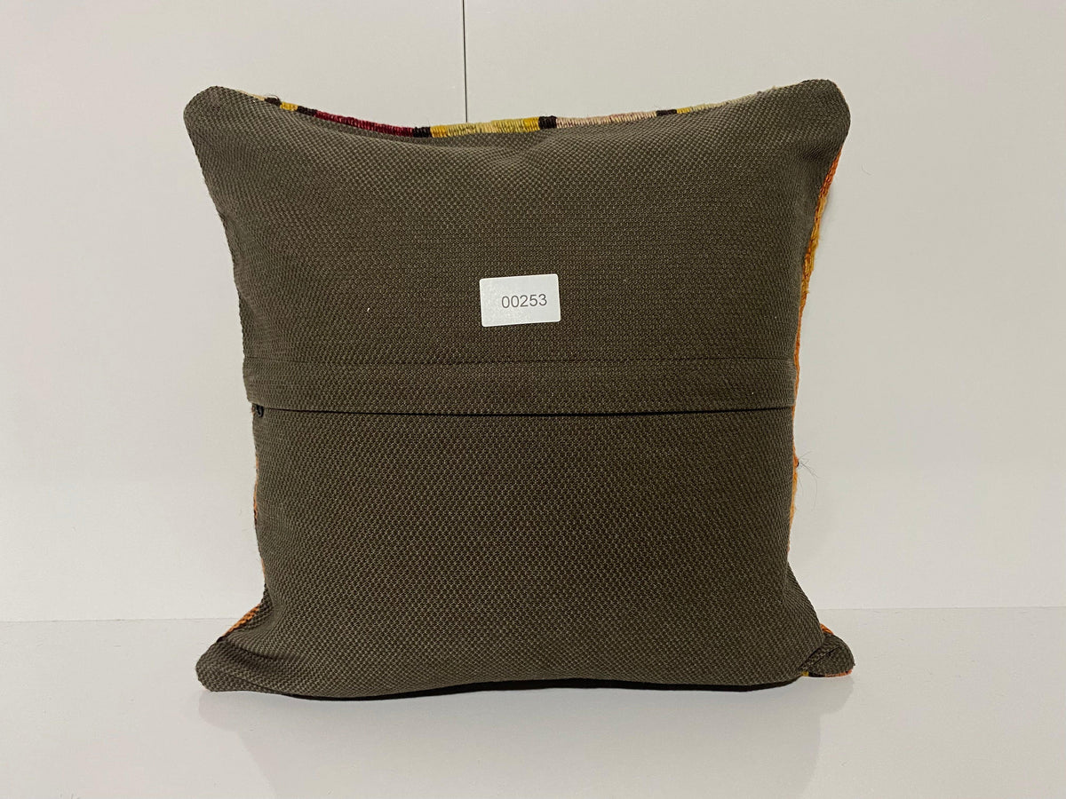 Close-up of the green Turkish kilim pillow showing traditional details.