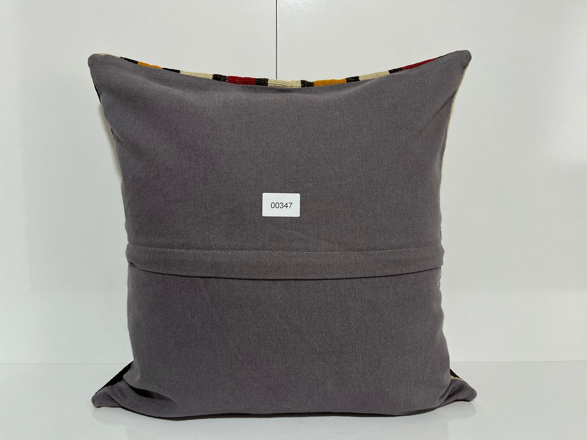 Close-up of the white Turkish kilim pillow showing striped details.
