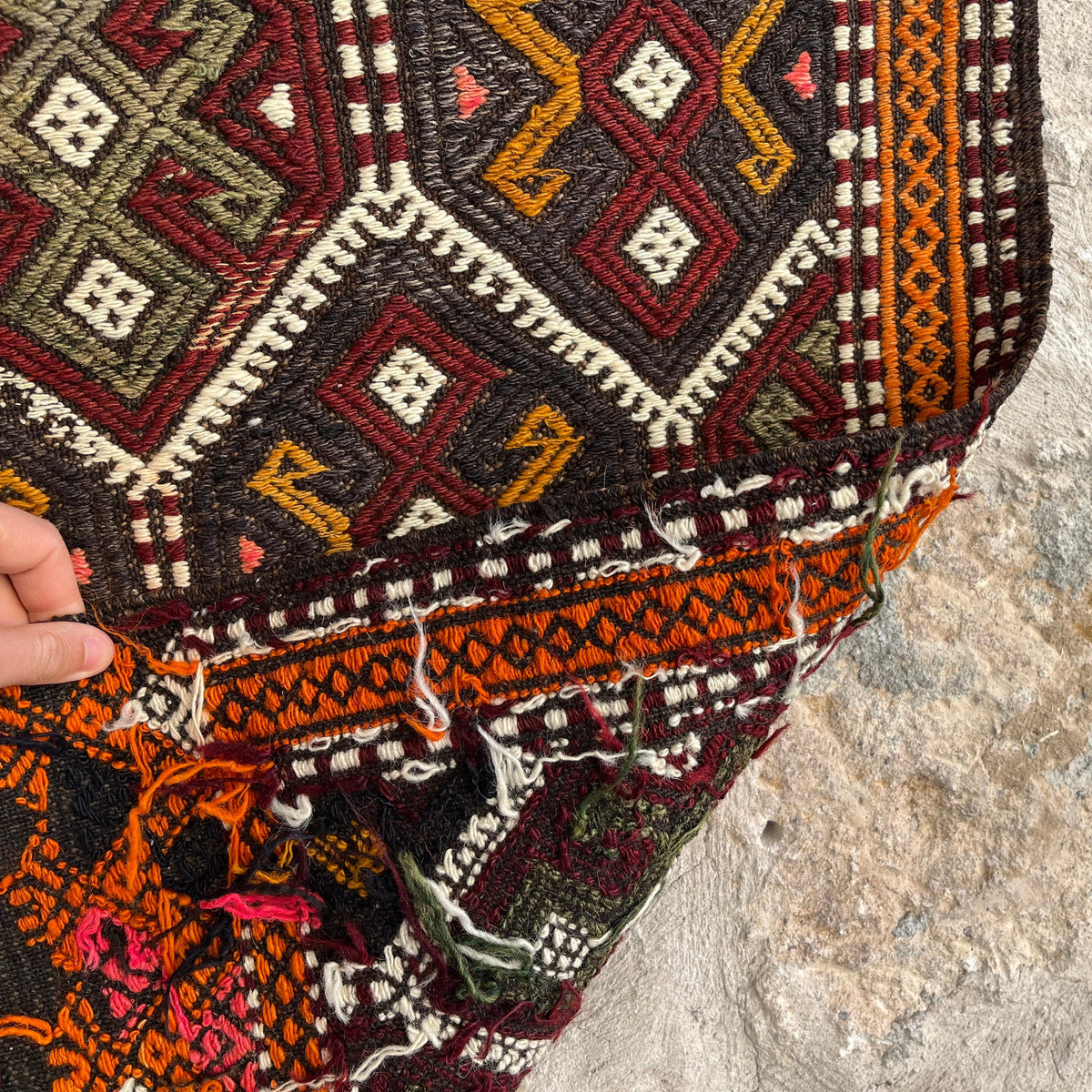 Close-up of the orange Turkish kilim rug showing traditional details, flatweave construction, wool and cotton and low pile.
