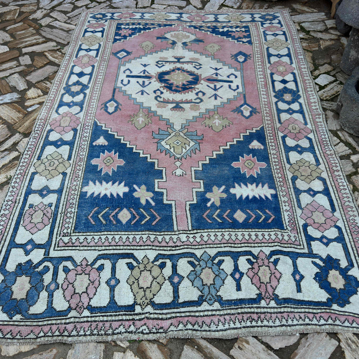 Blue 6' x 10' large turkish rug in wool and cotton, shown on the floor.