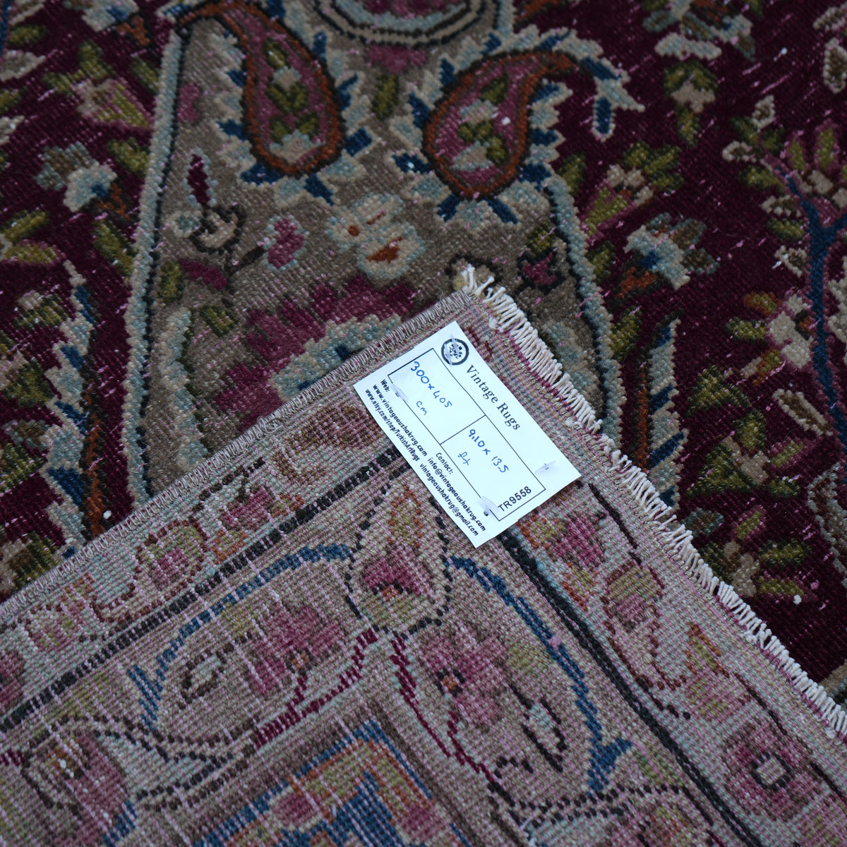 Additional view of the burgundy large vintage persian rug in wool and cotton.