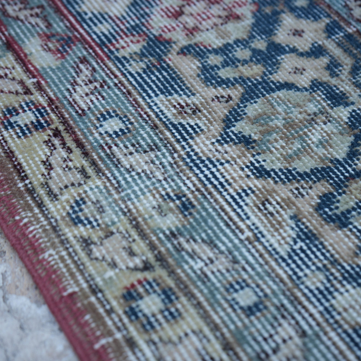 Red 7' x 9' Turkish large vintage rug in wool and cotton, shown on the floor.