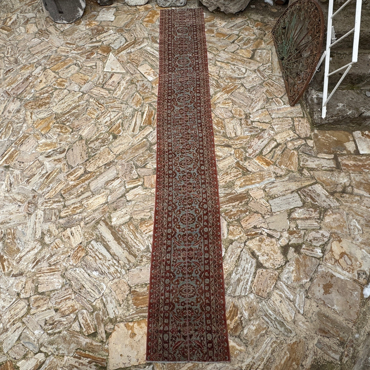 Brown 2' x 15' long persian runner rug in wool and cotton, shown on the floor.