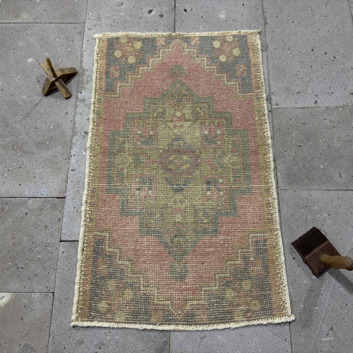 Pink 2' x 3' Turkish mini anatolian rug in wool and cotton, shown on the floor.