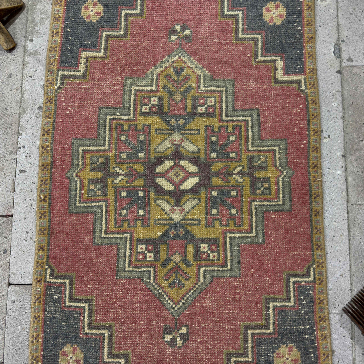 1970s red Turkish mini anatolian rug with traditional design, hand-knotted weave and low pile.