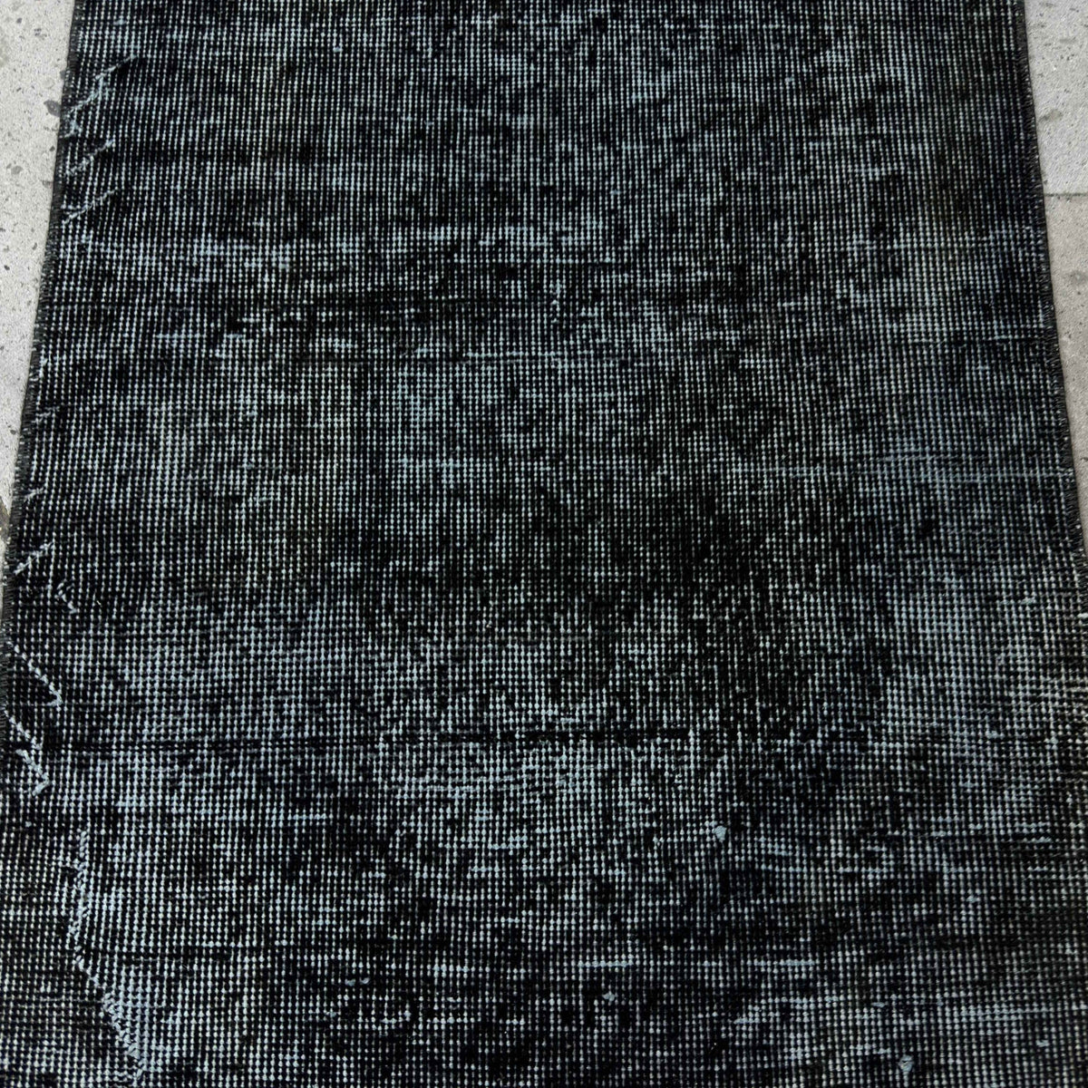 1970s black Turkish mini overdyed rug with overdyed design, hand-knotted weave and low pile.