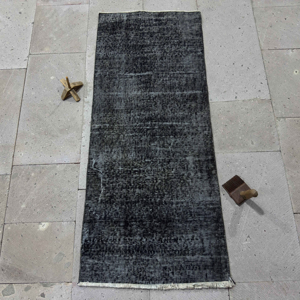 Black 2' x 4' Turkish mini runner rug in wool and cotton, shown on the floor.