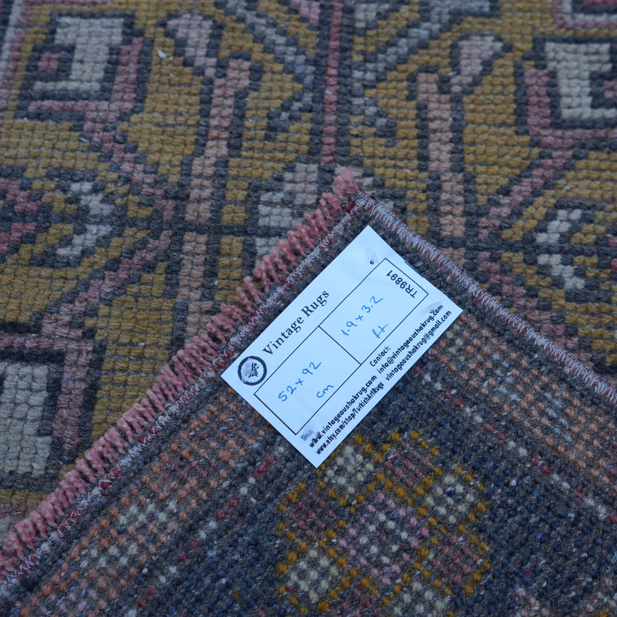 Red 2' x 3' mini turkish rug from the 1970s with traditional design.