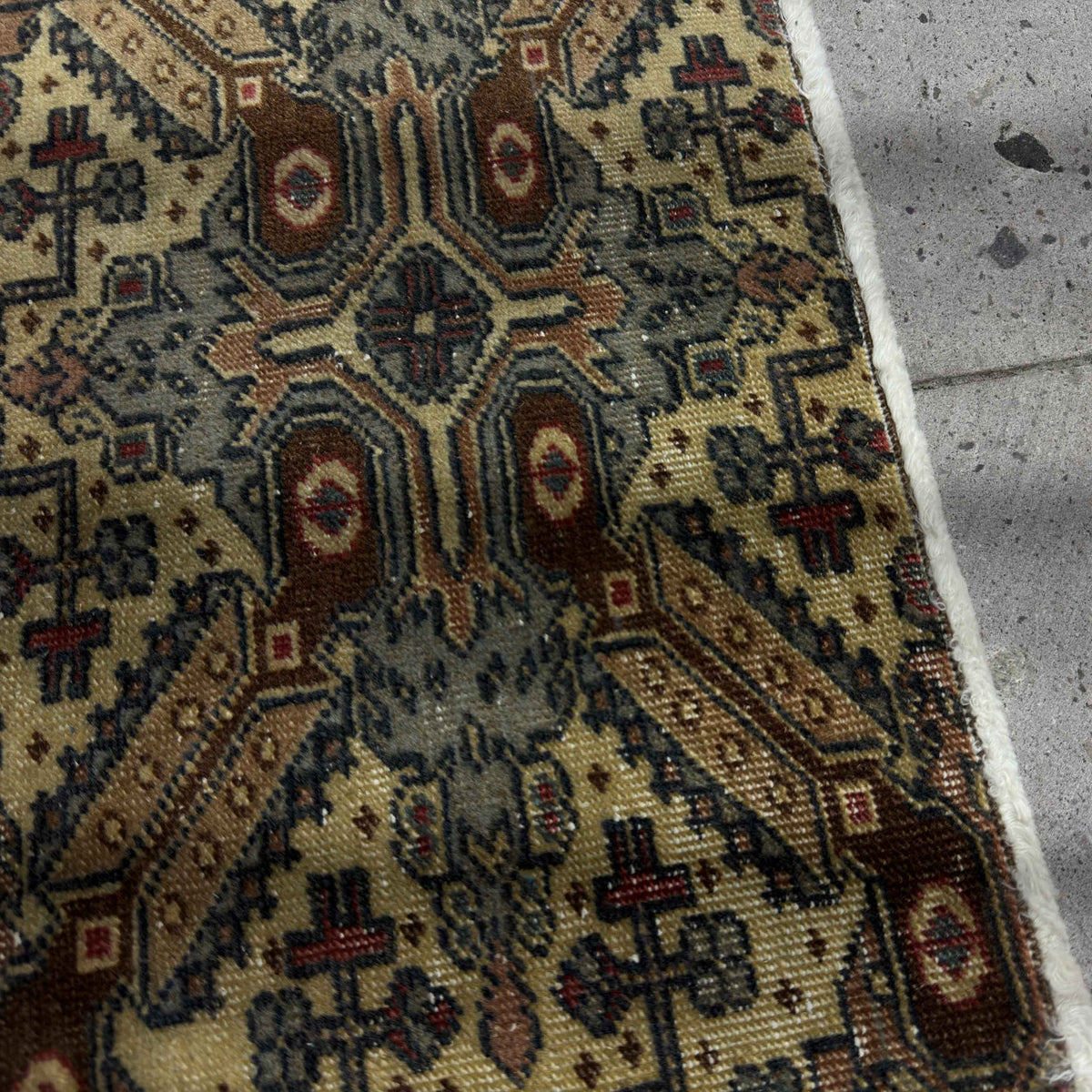 Close-up of the brown Turkish mini vintage rug showing neutral details, hand-knotted weave, wool and cotton and low pile.