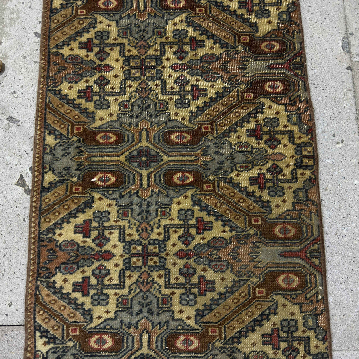 1970s brown Turkish mini vintage rug with neutral design, hand-knotted weave and low pile.