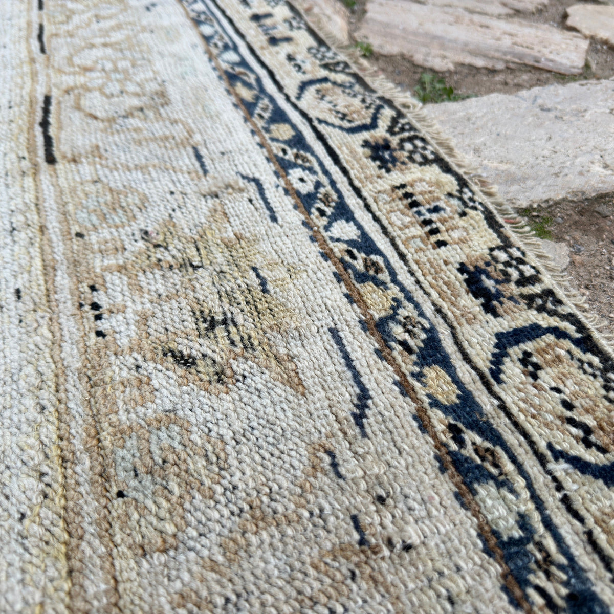 Close-up of the beige Turkish oriental wool rug showing neutral details, hand-knotted weave, wool and cotton and low pile.