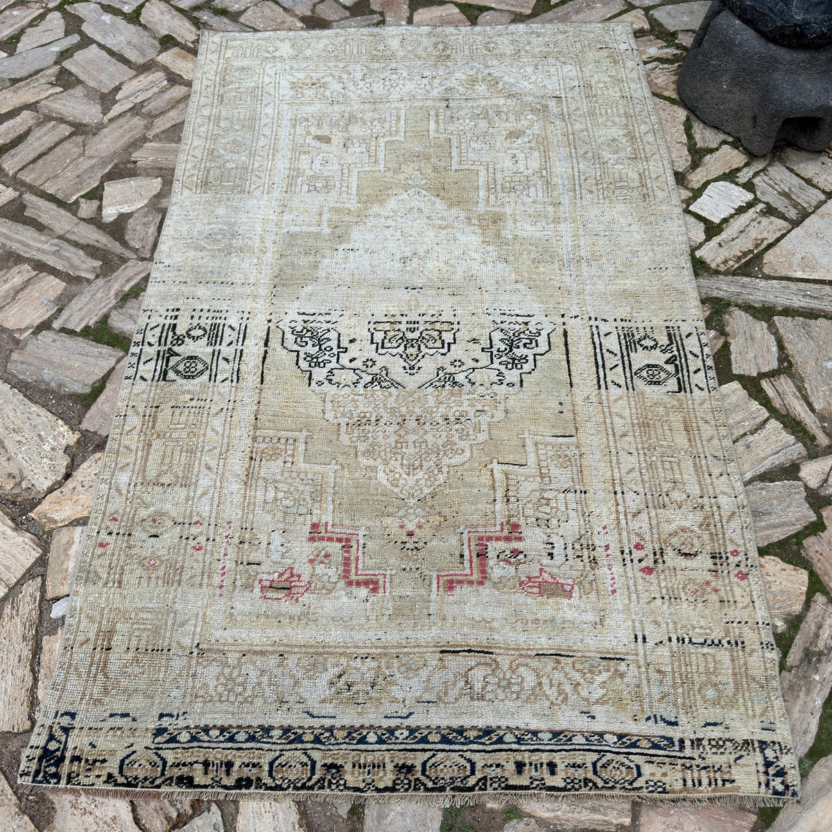 Beige 4' x 7' Turkish oriental wool rug in wool and cotton, shown on the floor.