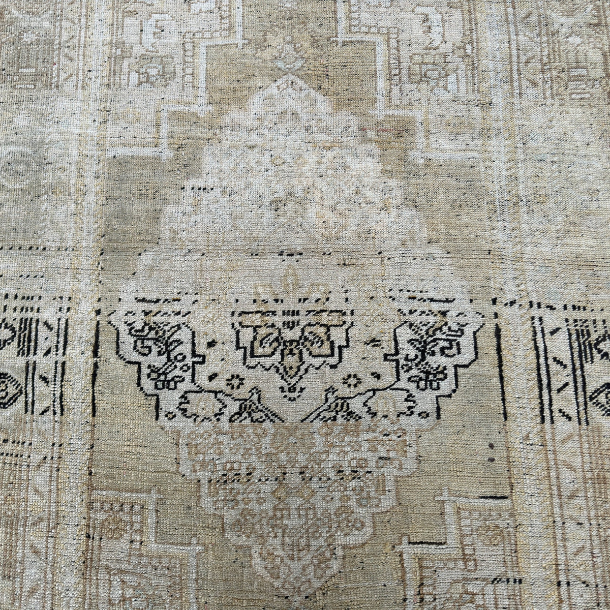 1970s beige Turkish oriental wool rug with neutral design, hand-knotted weave and low pile.