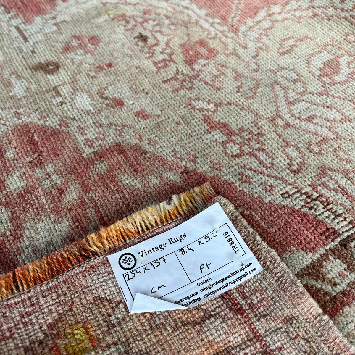 Red 5' x 8' Turkish oriental wool rug in wool and cotton, shown on the floor.