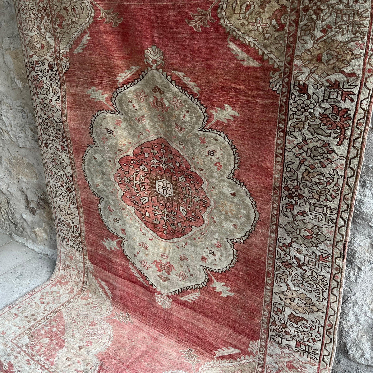 1970s red Turkish oriental wool rug with medallion design, hand-knotted weave and low pile.