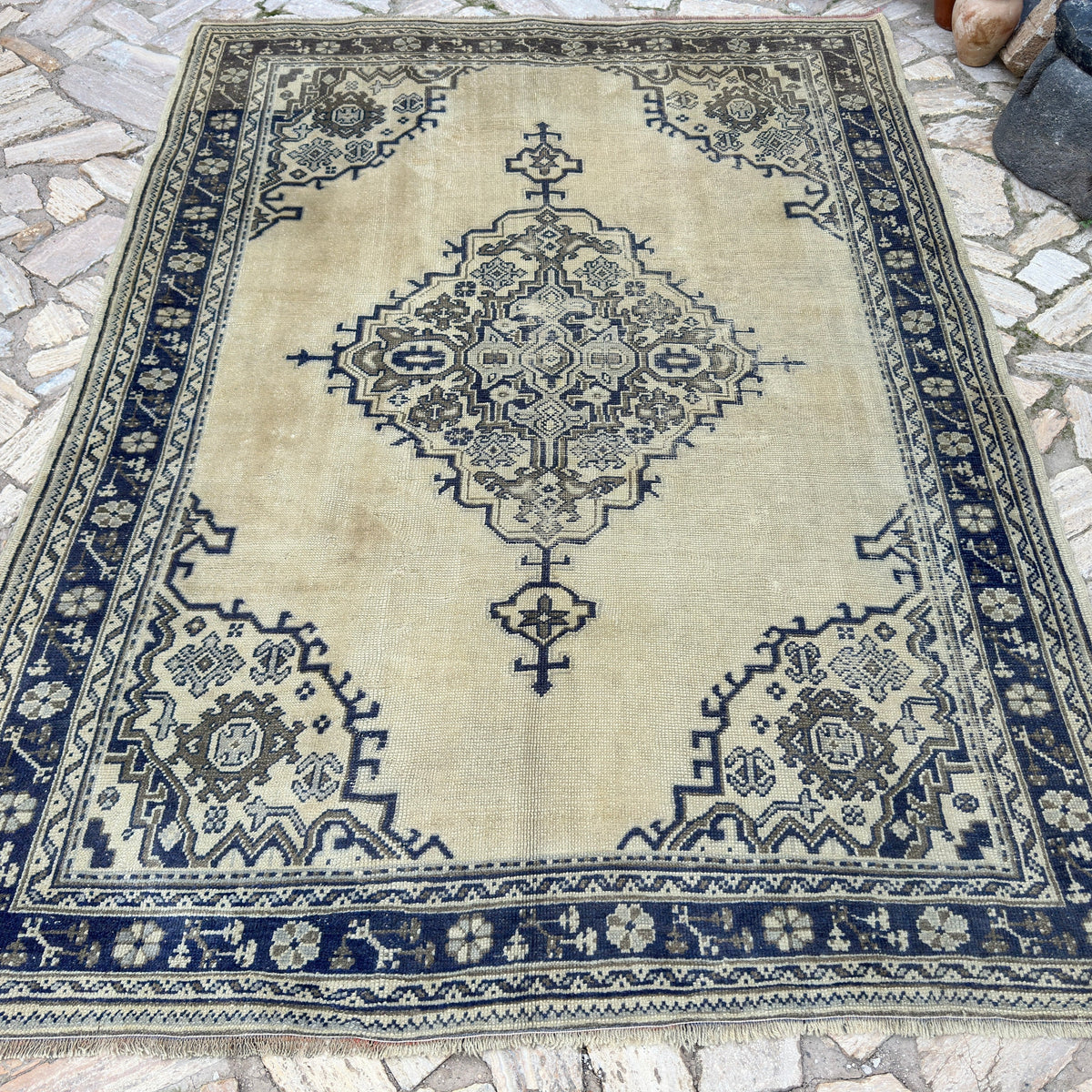 Blue 6' x 9' Turkish oushak rug in wool and cotton, shown on the floor.