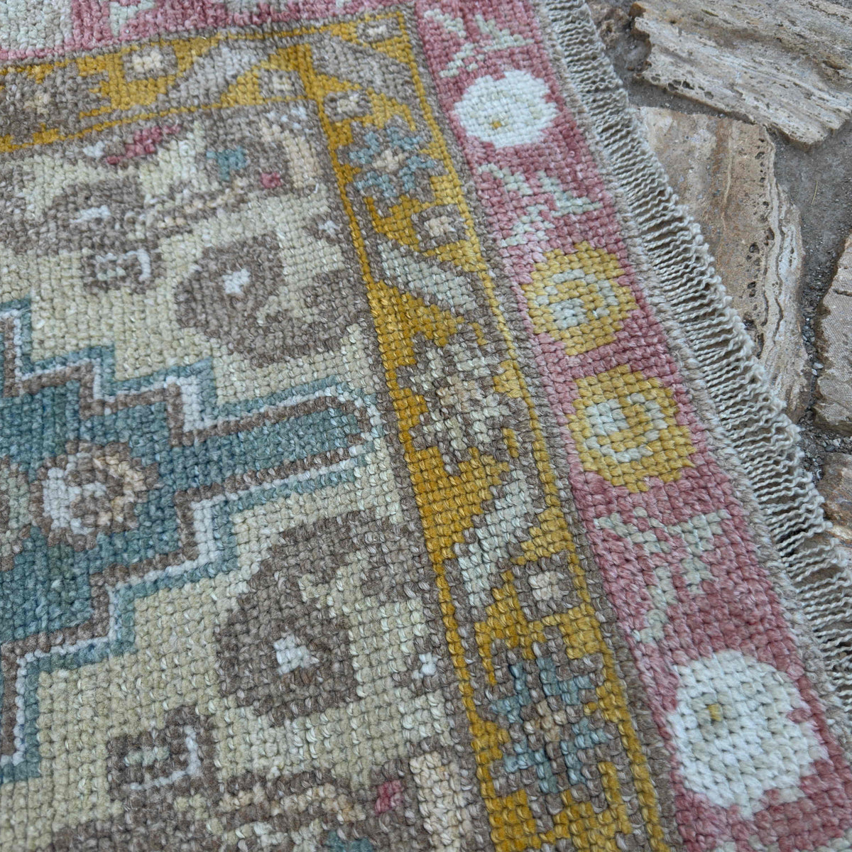 Close-up of the green Turkish oushak runner rug showing oushak details, hand-knotted weave, wool and cotton and low pile.