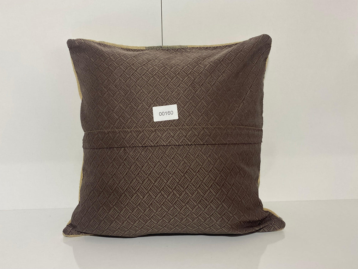 Close-up of the beige Turkish pillow cover showing striped details, low pile.
