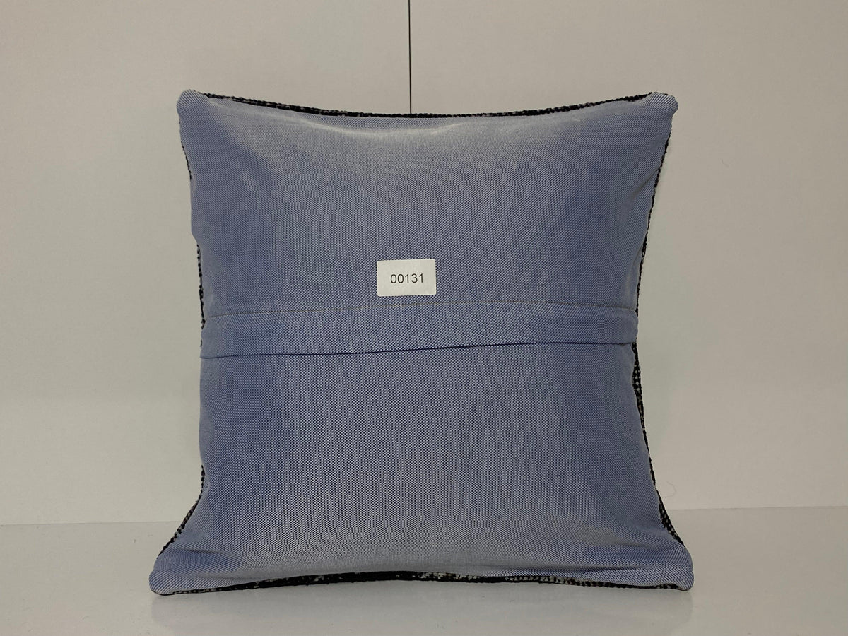 Close-up of the black Turkish pillow cover showing overdyed details, low pile.