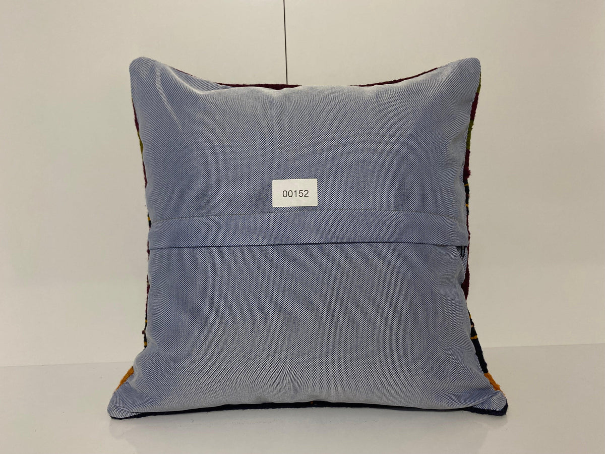 Close-up of the colorful Turkish pillow cover showing striped details, low pile.