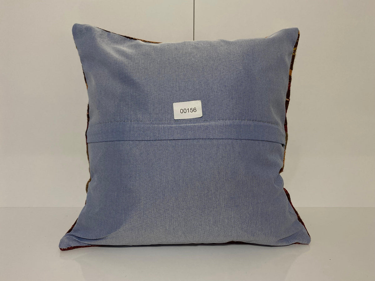 Close-up of the colorful Turkish pillow cover showing striped details, low pile.