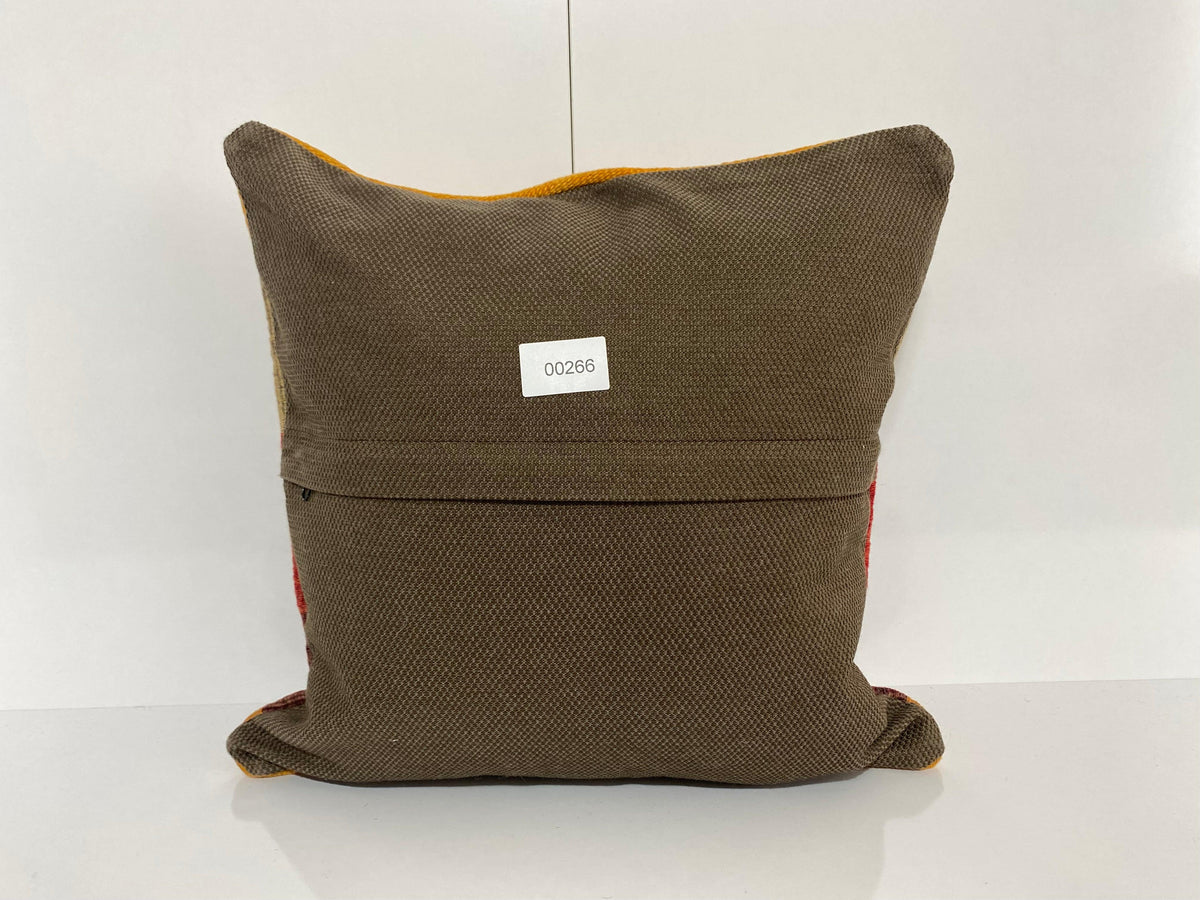 Close-up of the colorful Turkish pillow cover showing striped details, low pile.