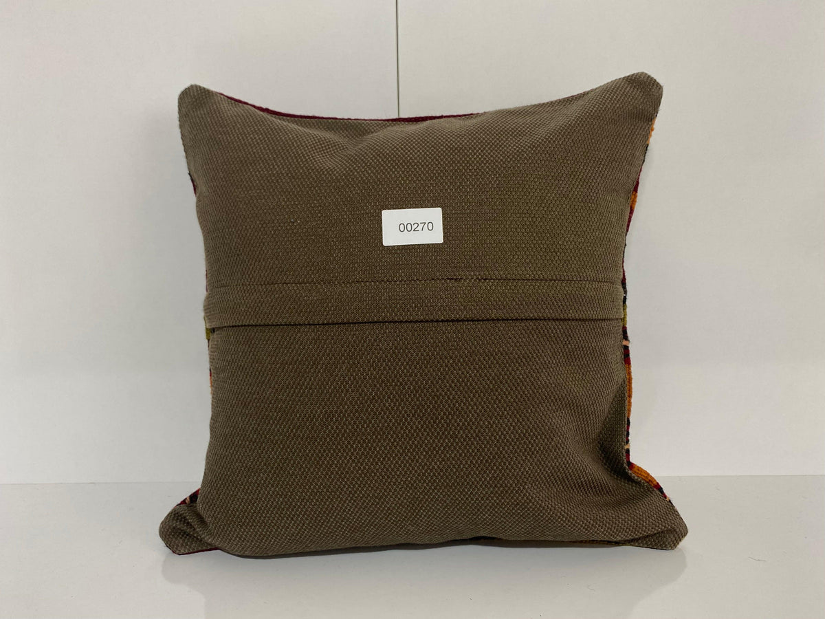 Close-up of the colorful Turkish pillow cover showing striped details, low pile.