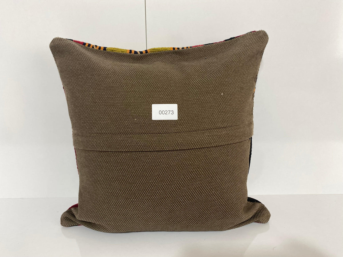 Close-up of the colorful Turkish pillow cover showing striped details, low pile.