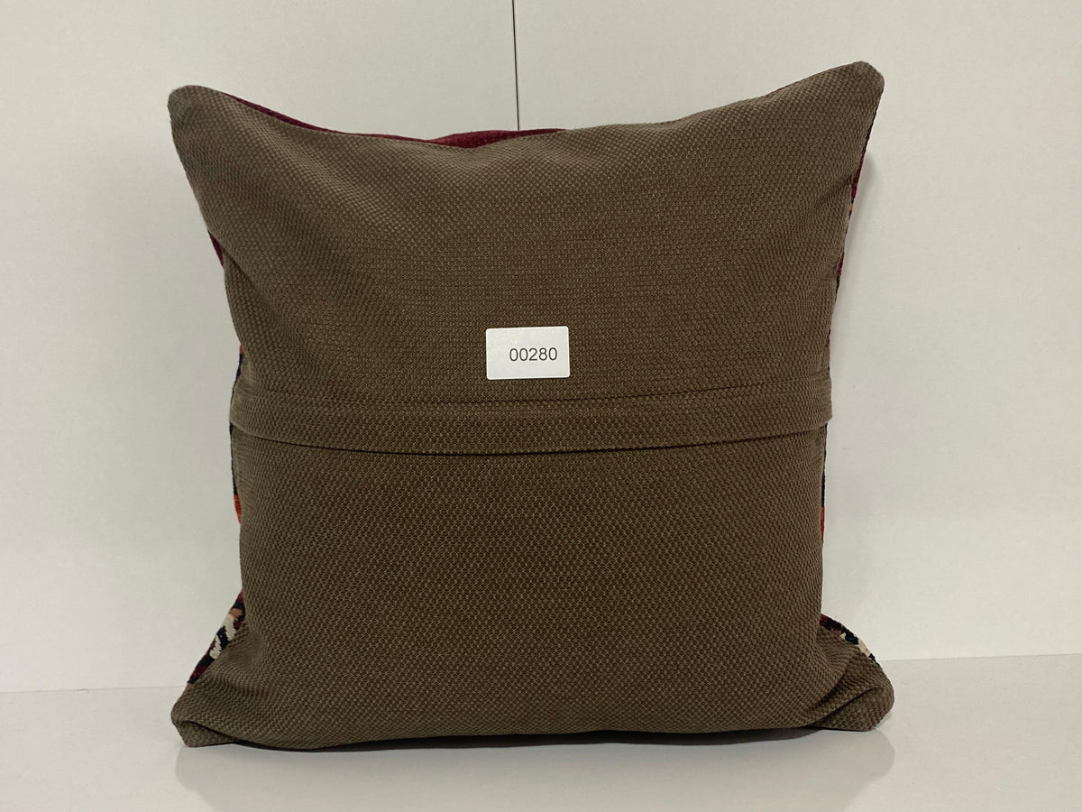 Close-up of the red Turkish pillow cover showing striped details, low pile.